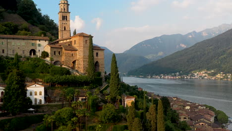 Cinematic-close-up-drone-shot-of-Chiesa-di-Santa-Maria-del-Sasso-in-Switzerland-with-Lugano-lake-in-the-distance