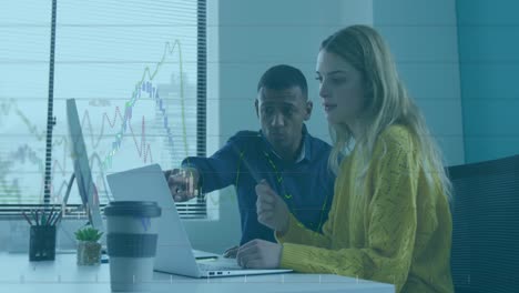 Animation-of-financial-data-processing-over-diverse-man-and-woman-discussing-over-a-laptop-at-office