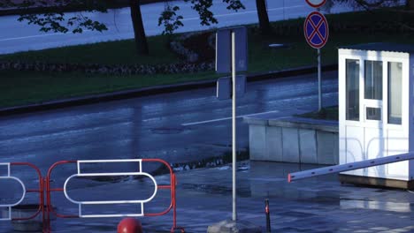 rainy city street scene with parking barrier