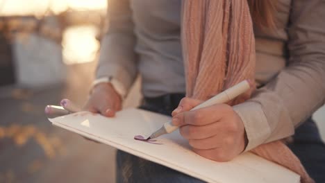 woman sketching outdoors at sunset