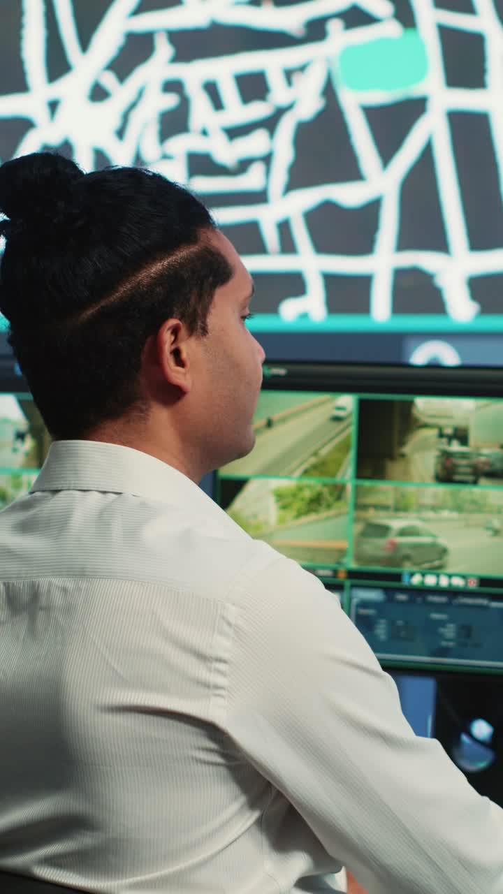 Man Monitoring Traffic Surveillance Cameras in Control Room