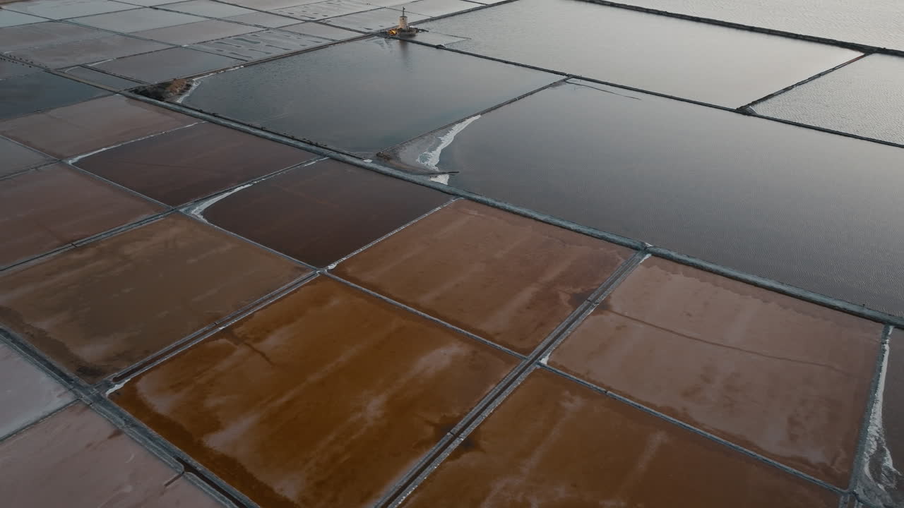Aerial of Marsala salt pans after sunset with warm orange tones