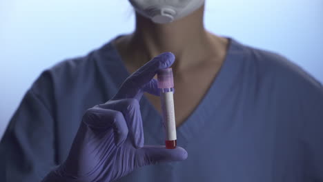 nurse holding a coronavirus blood test in a lab environment