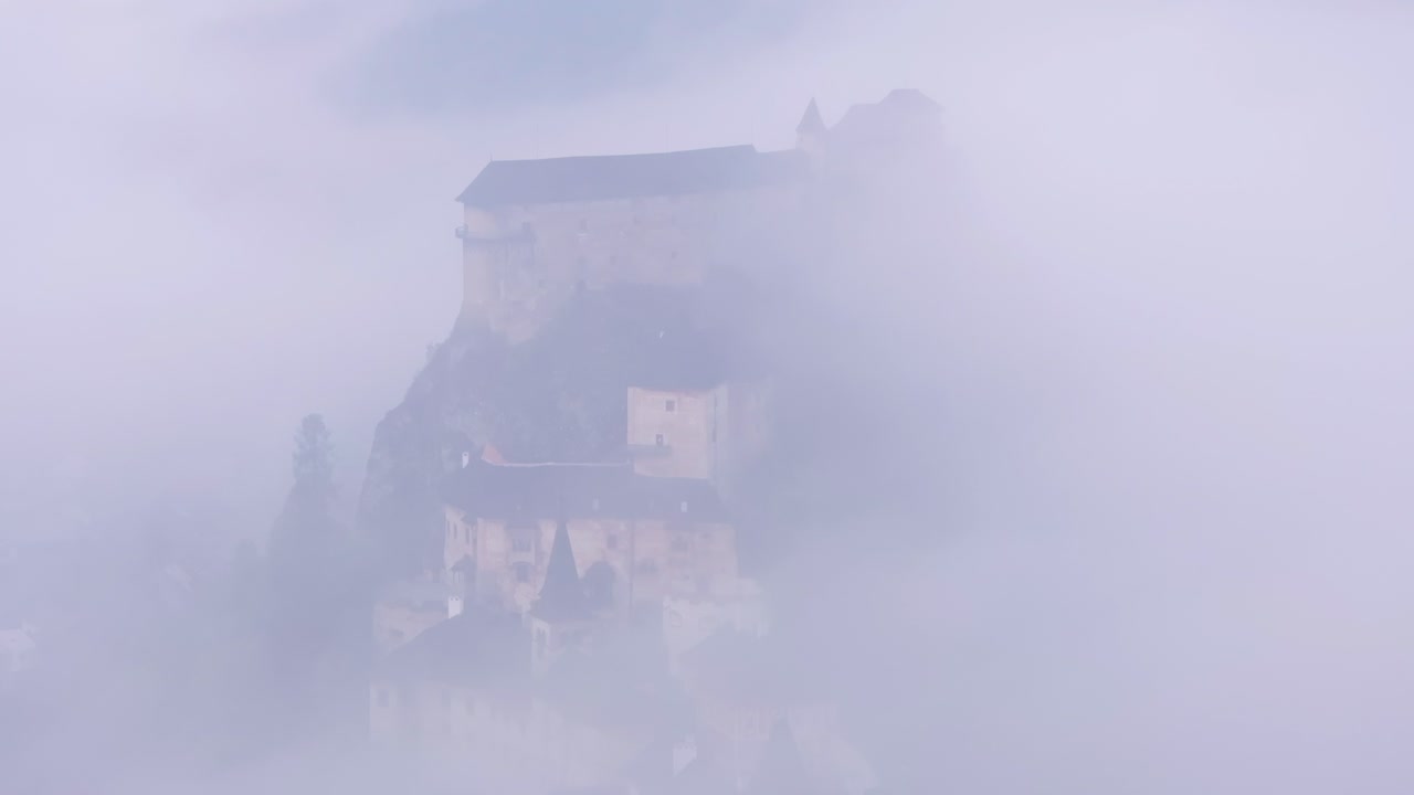 Aerial frame of Orava Castle glowing in early morning light, Slovakia