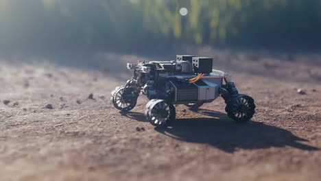 a small robotic rover on a dirt path with blurred green foliage in the background