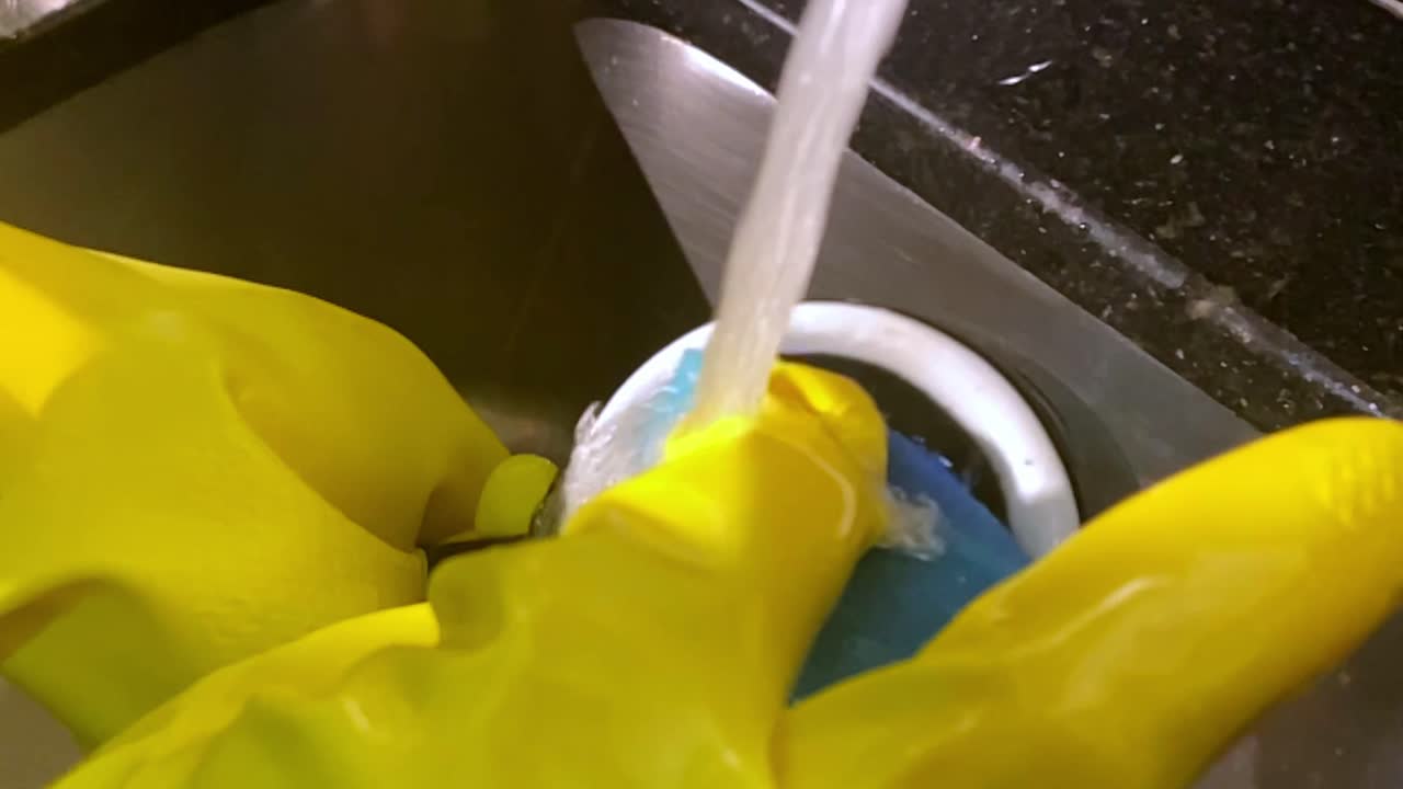 Household routines, slow motion water flowing, protective hand wear