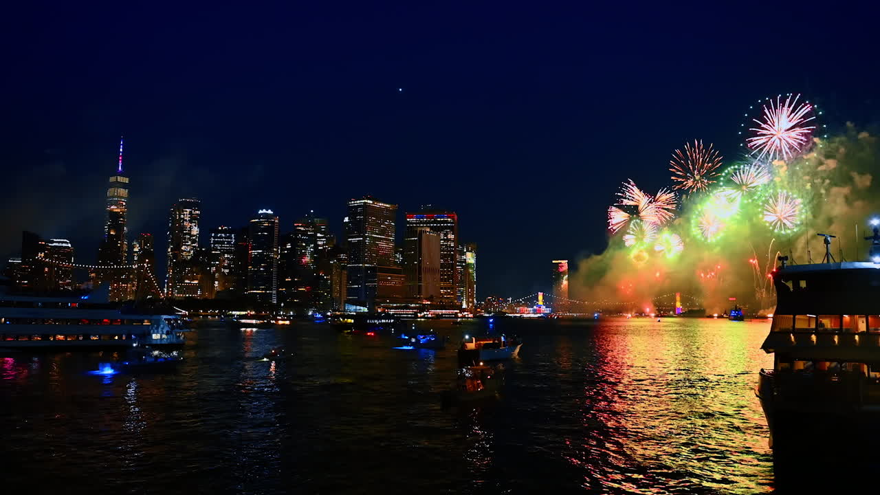 Beautiful fireworks on the 4th of July over the East River. New York celebration at night. Multiple boats watch the show