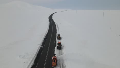 snowmobiles working on the road