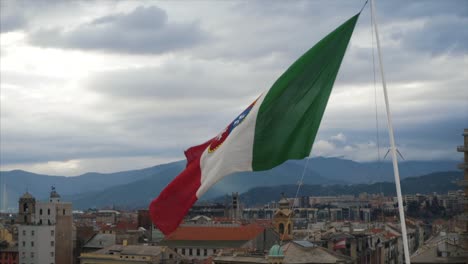 italian flag waving over a cityscape on a cloudy day