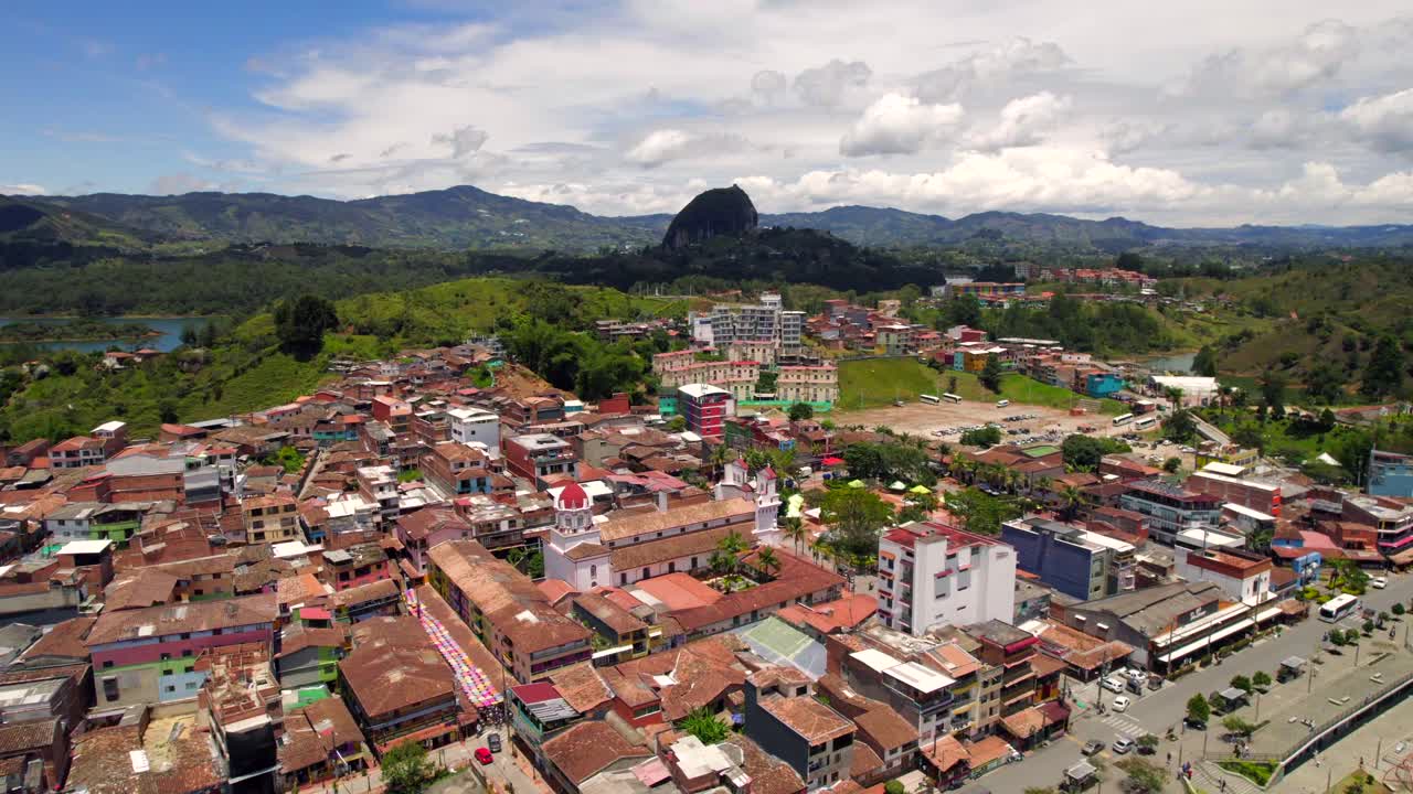 Brick buildings in the beautiful Latin village of Guatape with the Pe&ntilde;ol in the background