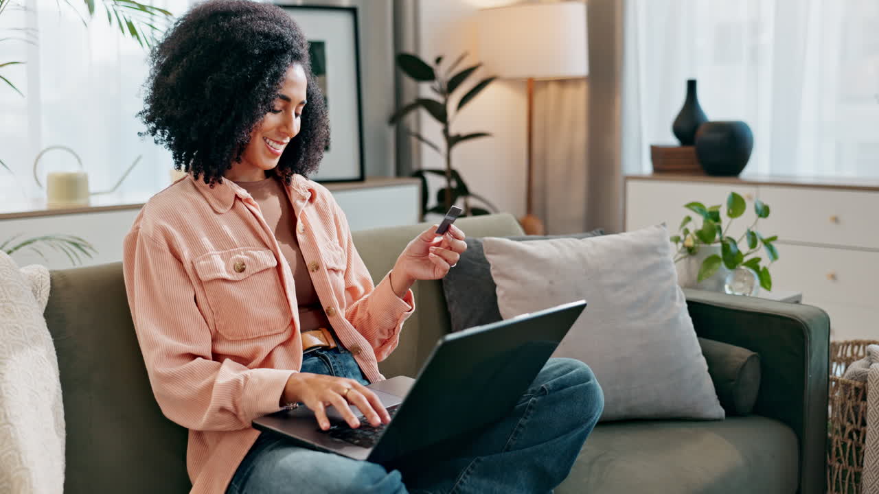 Woman using laptop and credit card for online shopping at home