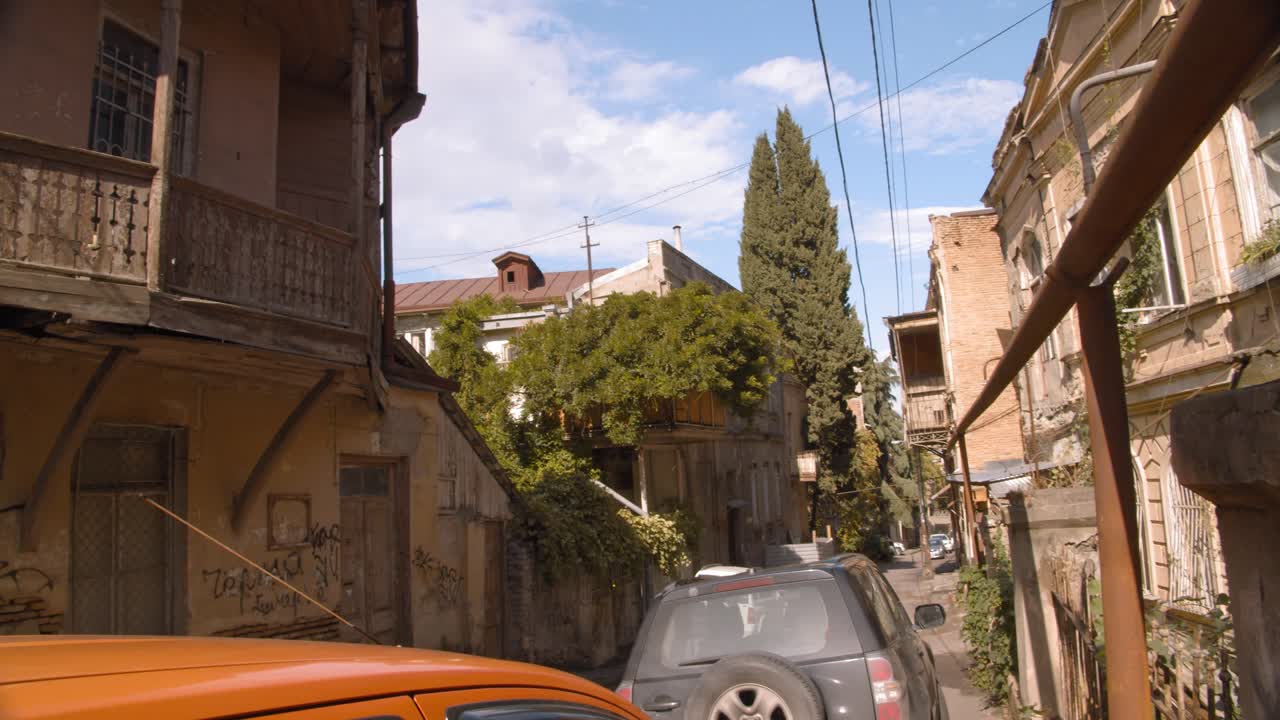 Tbilisi Georgia Dzveli area with old houses that were built in 19th century. Blue sky and clouds.
