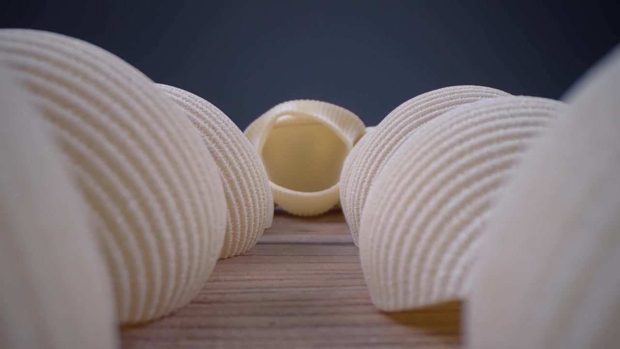 Macro Close-up of Uncooked Conchiglioni Pasta on a Wooden Table