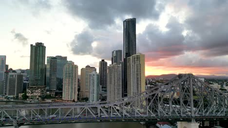 the beautiful story bridge in queensland australia with the city of brisbane etched against the sunset