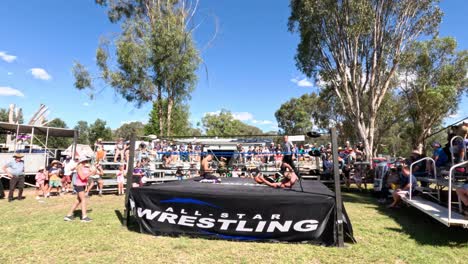 wrestlers competing in an outdoor ring