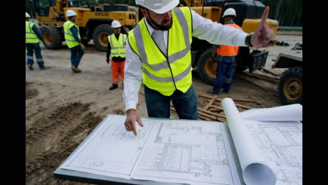 construction site engineer reviewing plans