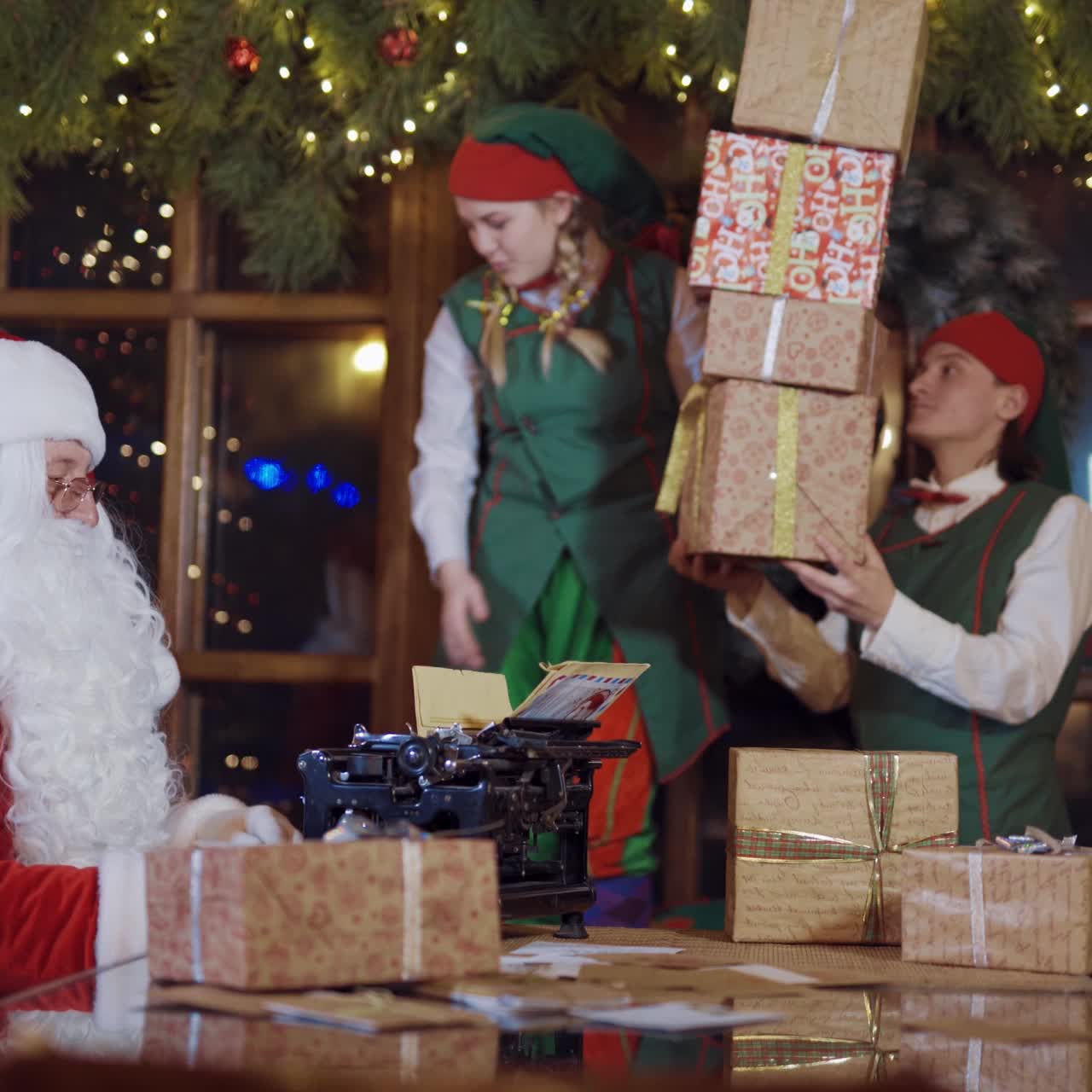 Santa Claus and elves with gift boxes