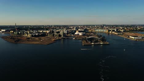 aerial tracking shot of the west waterfront of helsinki, golden hour in finland