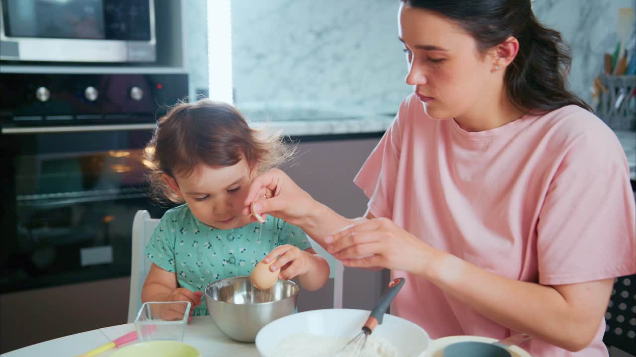 A Heartwarming Moment in the Kitchen: A Mother Engages in Baking with Her Young Daughter, Sharing Joy and Learning in a Cozy Home Environment