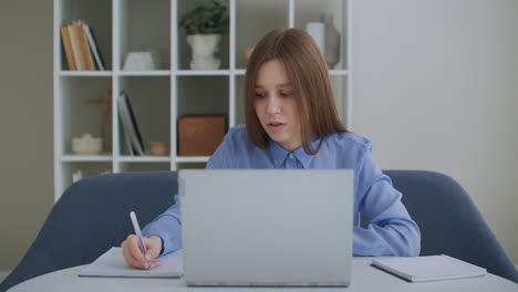 focused business woman entrepreneur typing on laptop doing research. young female professional using computer sitting at home office desk. busy worker freelancer working on modern tech notebook device