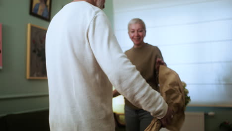 man bringing flowers to woman