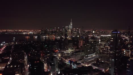 the new york city skyline at night, taken from a drone