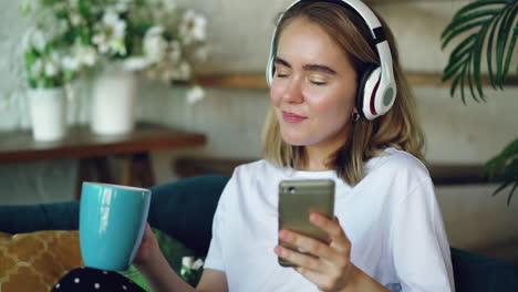 young woman relaxing with headphones and phone