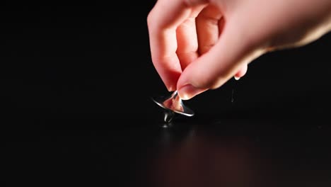 hand spinning a top on a surface