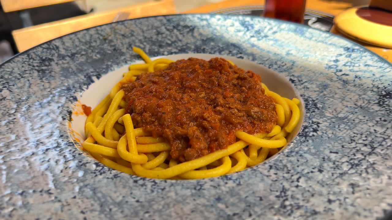 Pasta fresca tradizionale con ragù alla bolognese di manzo, cibo italiano, ripresa 4K.