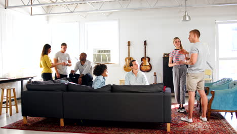 friends talking at a party in a brooklyn loft apartment