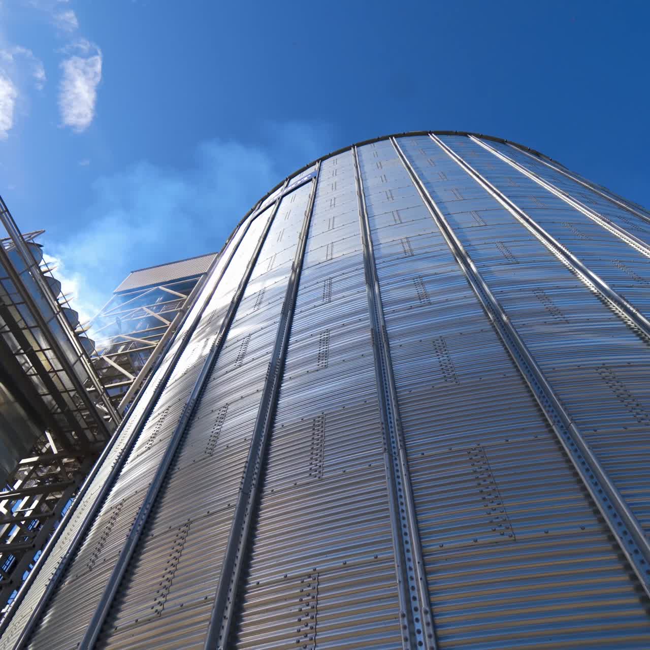 Modern commercial grain silos. Agricultural elevator building for grain storage