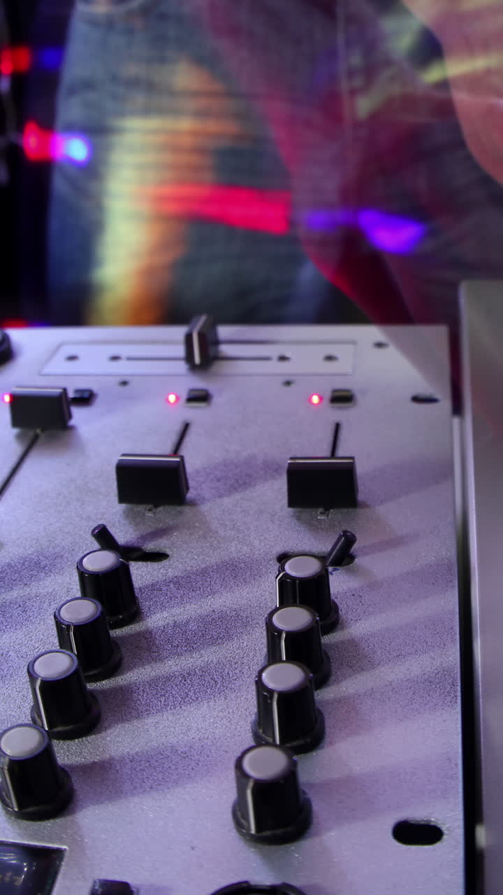 dj masculino detrás de los tocadiscos en vertical