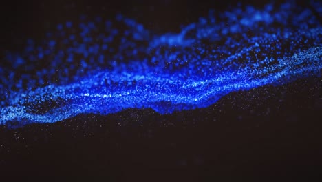 animation of blue wave of spots on black background