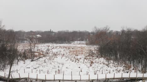 Drone-shot-flying-over-a-snow-covered-marsh