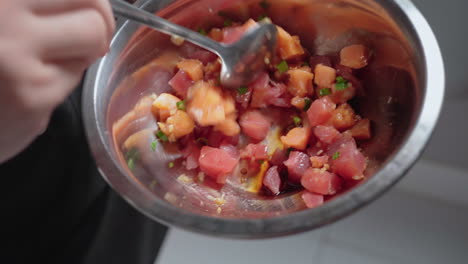 Mixing-Diced-Raw-Salmon-And-Tuna-With-Herbs-And-Soy-Sauce-In-A-Bowl