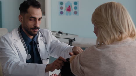 doctor checking patient's blood pressure