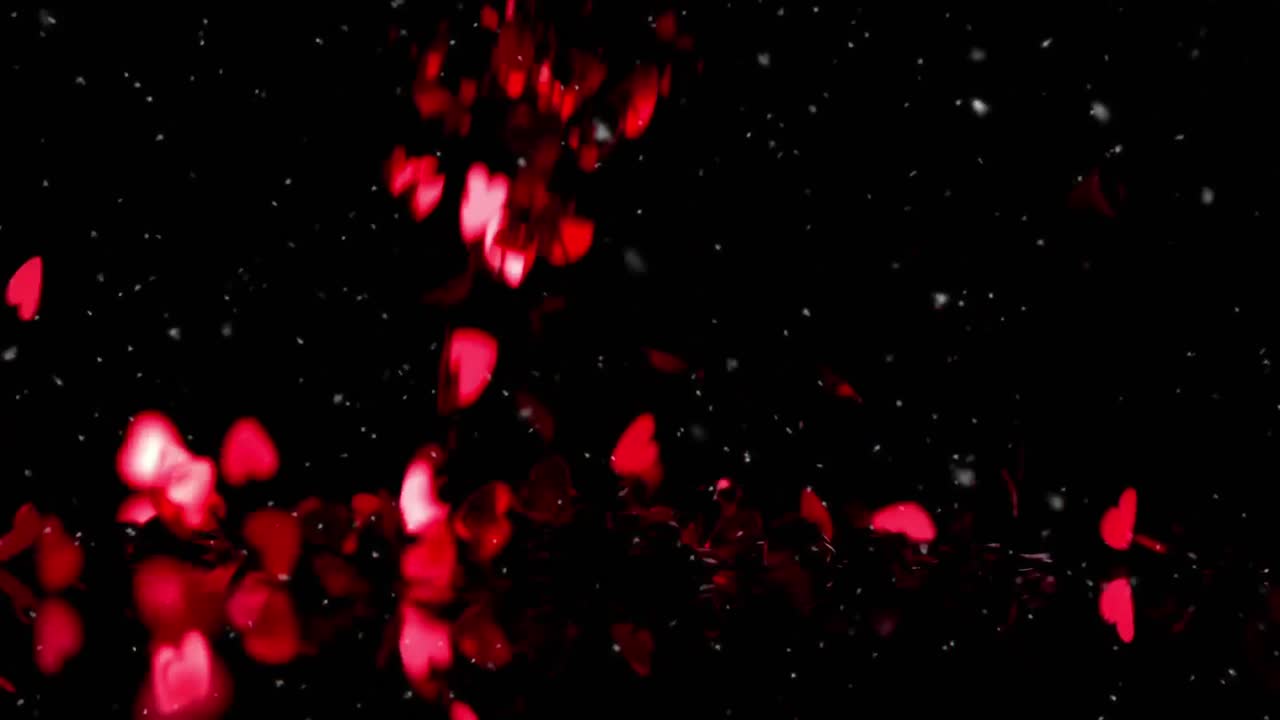 Animación de corazones rojos cayendo sobre fondo negro