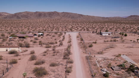 joshua tree california dirt road with houses in desert