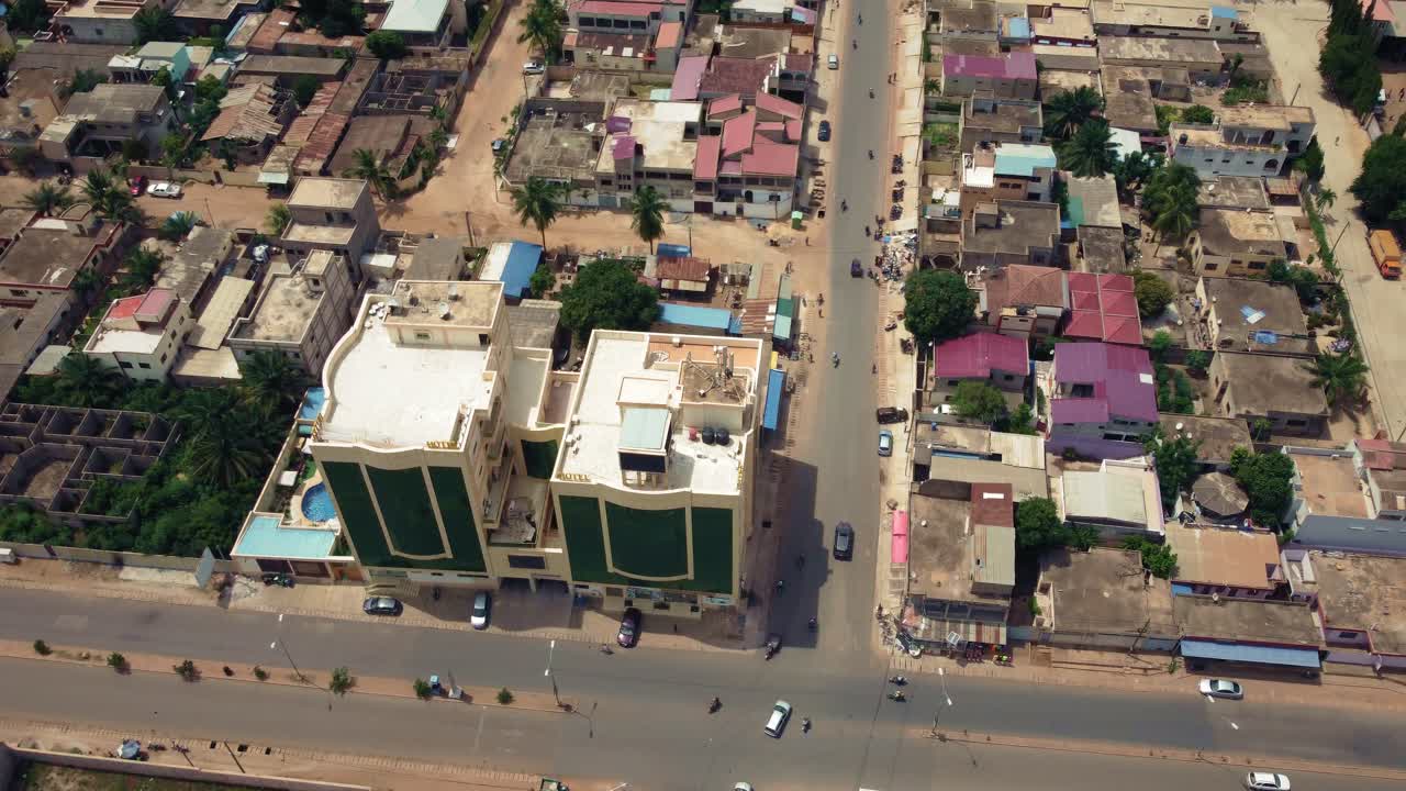 Cinematic Aerial View of African City traffic, showing Twin Towers building, Lomé, West Africa