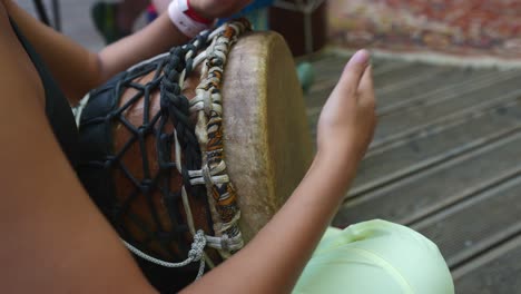 woman playing djembe drum