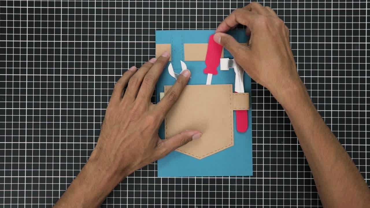 Hands Creating a gift card with a tool inspired theme