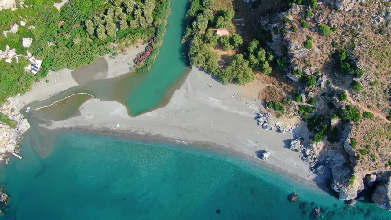 Aerial tilt revealing the pristine Kourtaliotis river and Preveli beach in the island of Crete