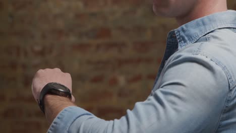 man checking smartwatch