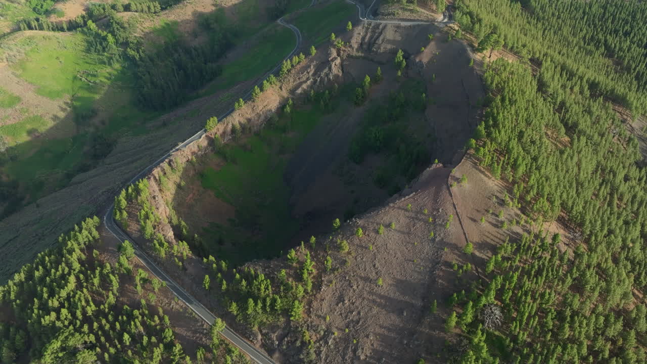 Aerial view of Caldera de Los Pinos de Galdar and surrounding pine trees in Gran Canaria at sunset