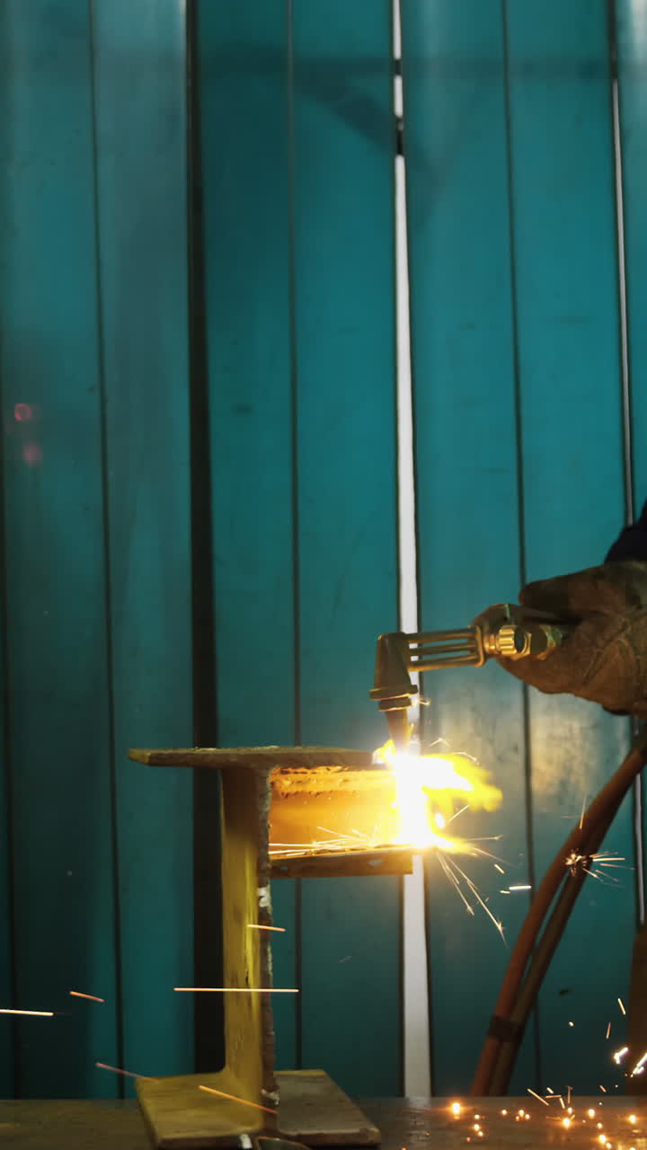 Male and female welders working in workshop