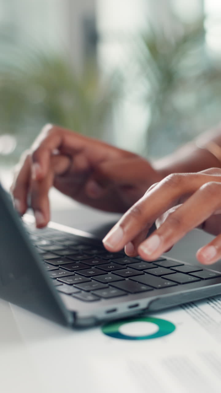 Close-up of Hands Typing on Laptop Keyboard in Office