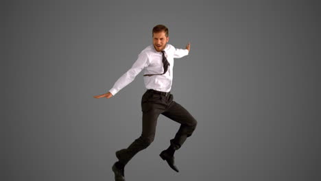 businessman jumping on grey background