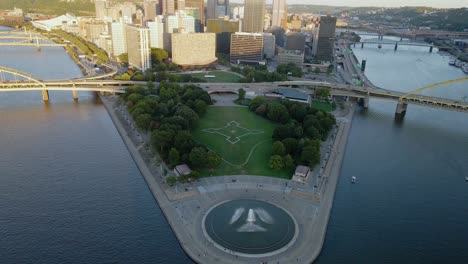 aerial view of the point state park and fountain, sunny morning in pittsburgh, usa - reverse, drone shot