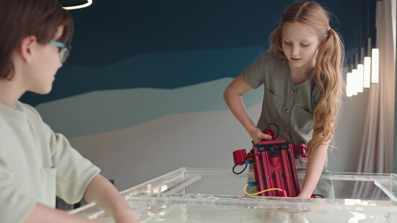 Pair of Kids Conducting Experiment with Robo Boat
