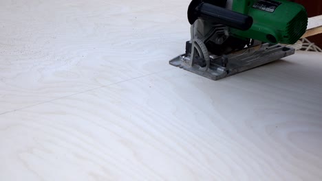 cutting wood with an electric hand saw. woodworking.